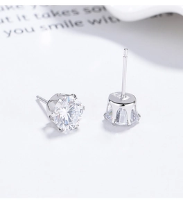 Close-up of 925 sterling silver stud earrings with classic six-prong zircon setting