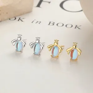 Macro shot of 925 silver bee earrings with colorful opal stones in gold and silver
