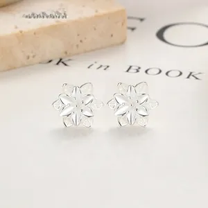 Detailed macro view of 925 sterling silver floral stud earrings with hollowed petals