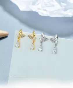 Detailed macro of 925 sterling silver leaf earrings with pear-shaped zircon stones