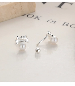 Detailed close-up of 925 silver bow pearl earrings with secure screw-back closure