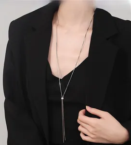 Detailed view of long Y-shaped 925 sterling silver snake chain necklace on model