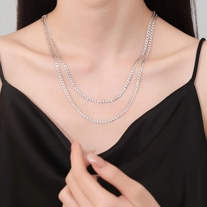 Elegant 925 sterling silver interlocking double chain necklace worn on a female model