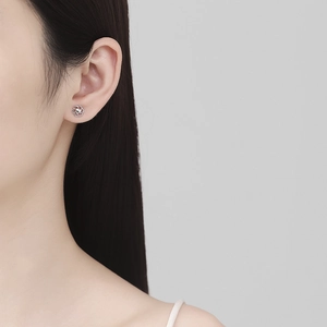 925 sterling silver hollow heart flower stud earrings worn by model for elegant style