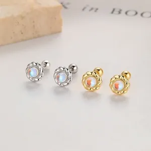Macro shot of 925 silver and gold flower petal earrings with iridescent moonstone centers
