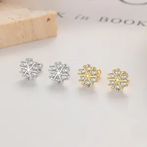 Close-up of snowflake silver studs with cubic zirconia and flat screw back closure