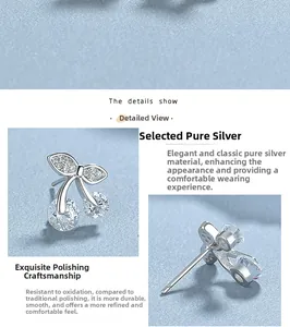 Détail macro de boucles d'oreilles cerises en argent S925 avec feuilles pavées et zirconiums