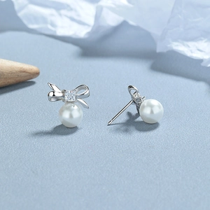 Elegant 925 sterling silver bow knot pearl stud earrings with sparkling cubic zirconia