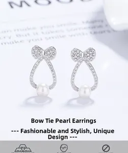Detailed view of 925 silver bow earrings with micro-pave crystals and white pearls