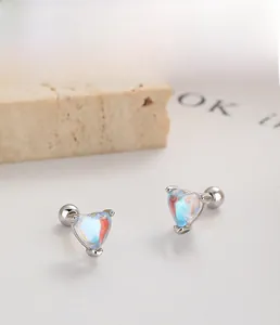 Macro detail of S925 sterling silver heart studs with opal stones and screw back closure