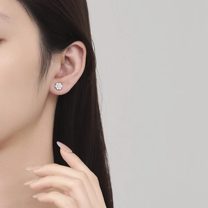 925 sterling silver snowflake stud earring with zircon inlay on female ear lobe