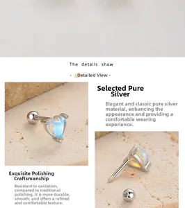 Macro detail of 925 sterling silver heart earrings with screw back and iridescent stone