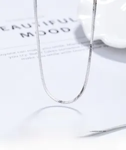 Detailed close-up of a minimalist 925 sterling silver flat snake chain necklace