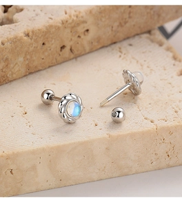 Macro detail of 925 silver moonstone stud earrings with twisted rope border and screw back