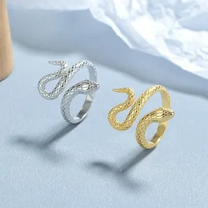 Detailed macro view of snake-shaped rings with scale texture in silver and gold