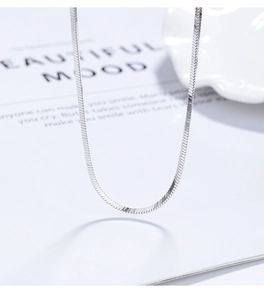 Macro shot of 925 sterling silver flat snake chain with premium metallic luster