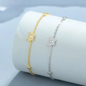 Detail of silver butterfly bracelet with pave stones on light gray jewelry stand