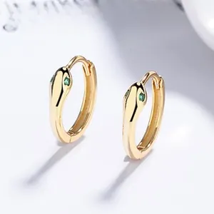 Detailed view of S925 sterling silver snake earrings with green gemstone eyes and gold finish