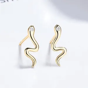 Detailed macro view of S925 gold snake earrings featuring sparkling zircon stone settings
