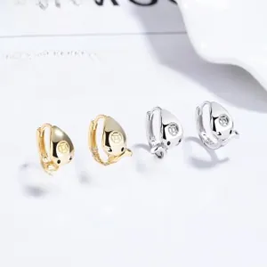 Polished gold and silver teardrop hoop earrings displayed on a minimalist white card