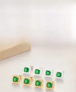 Detailed macro view of S925 silver square emerald stud earrings in gold and silver finish