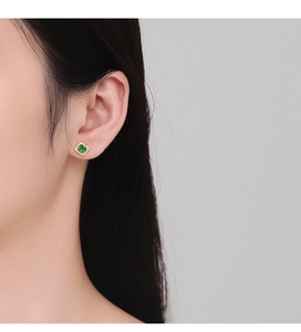 Close-up of vintage emerald-cut square zircon earring worn on a model's earlobe