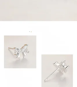 Macro detail of 925 sterling silver bow earrings featuring heart-shaped zircon stones