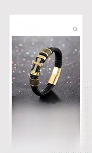 Detail view of woven black leather bracelet with golden cross and textured metal beads