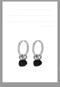 Macro view of silver metal hoop earrings with black geometric faceted pendants for men