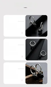 Macro details of silver punk hoop earrings featuring multi-faceted black resin beads