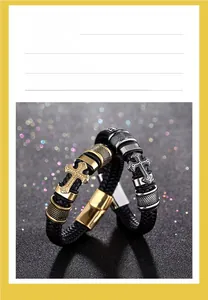 Detail of woven leather bracelets with cross charms in gold and steel finishes