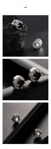 Détail de boucles d'oreilles magnétiques serties de zircons noirs et transparents
