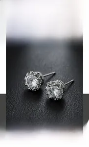 Macro detail of crown setting stud earring with round zircon in polished titanium steel