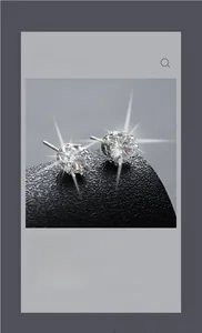 Detail of silver star earrings with zircons on dark leather texture and starburst lighting