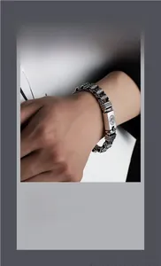 Macro shot of retro silver bracelet with intricate ethnic patterns and carved rectangular plate