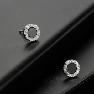 Minimalist silver round stud earrings with black center and textured metal edge for men