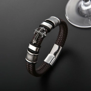 Braided brown leather cross bracelet with polished magnetic clasp on black background
