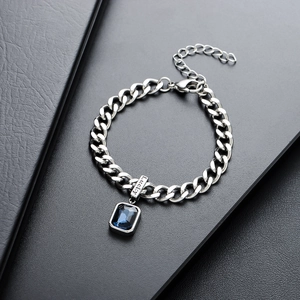 Silver Cuban chain bracelet with lucky engraving and a deep blue rectangular gemstone