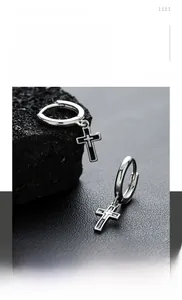 Detail of cross earrings in titanium steel with black inlay on volcanic rock
