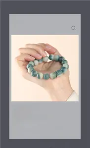 Close-up of natural green jade Bodhi seed bracelet with a silver Sanskrit charm