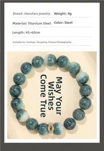 Macro detail of teal beads with Tibetan silver spacer and engraved spiral patterns