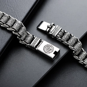 Retro silver metal bracelet featuring engraved mantra beads and embossed clasp details