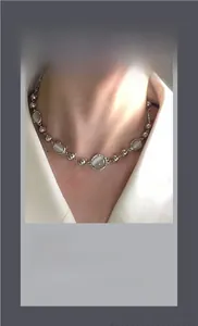 Detail of silver beaded necklace with grey cat's eye stone for men and women