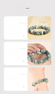 Macro view of green natural Bodhi beads bracelet with silver character charm