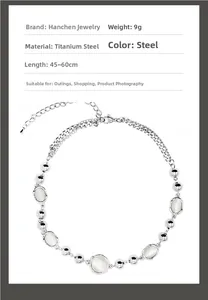Detailed view of titanium steel necklace with white cat eye stones and 9g weight info