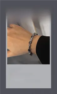 Neutral beaded bracelet with grey natural stones and silver metallic spacer beads on wrist