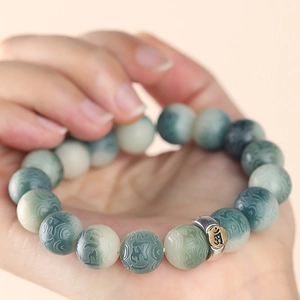 Handcrafted Bodhi seed bracelet with blue gradient beads and silver mantra charm