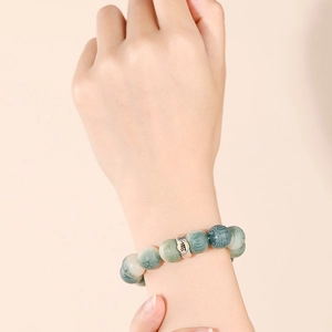 Natural white jade bodhi bead bracelet with vintage green tones and silver metal charm
