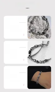 Macro detail of minimalist beaded bracelet with textured dark stones and metallic spacers