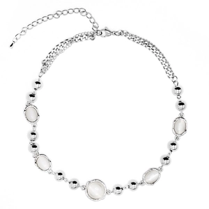 Elegant silver necklace with five oval moonstones and metal beads on white background